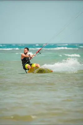 a man on a board in the water at SELENA BAY RESORT WITH PRIVATE BEACH,SEA VIEw in Hurghada