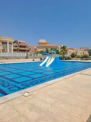 a swimming pool with a slide in the water at selena bay resort hurgada in Hurghada