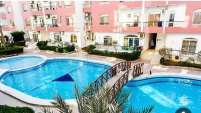 a large swimming pool in front of a building at استديو هادي بوسط المدينه in Hurghada