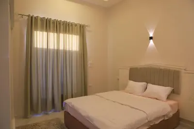 a bedroom with a bed and a window with a light at Royal Nile Villa - Nile View Apartment 1 in Luxor