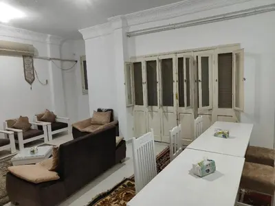 a living room with a table and a couch at happy home in Luxor