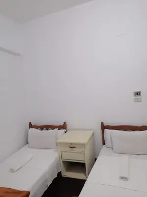 two beds sitting next to each other in a room at happy home in Luxor