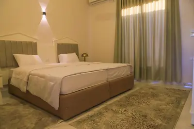 a bedroom with a large bed in a room at Royal Nile Villas - Nile View Apartment 2 in Luxor