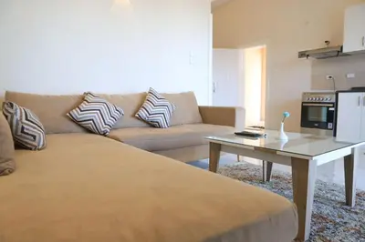 a living room with a couch and a table at Royal Nile Villas - Nile View Apartment 2 in Luxor