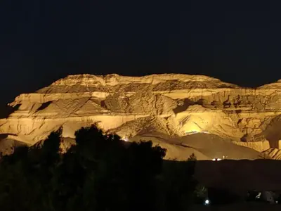 a mountain at night with lights on it at Villa Bauhaus in Al Aqālitah