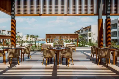 an outdoor dining area with tables and chairs at JAZ Elite Amara in Marsa Alam City