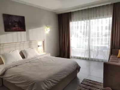 a bedroom with a bed and a large window at scandic resort in Hurghada