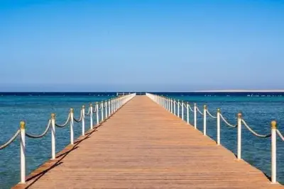 a wooden pier stretches out over the water at scandic resort in Hurghada