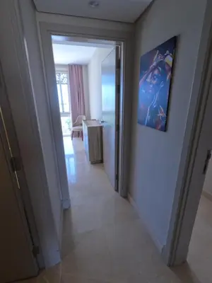 a hallway leading to a room with a painting on the wall at El Gouna Mangroovy 2Bd - M10 in El Gouna