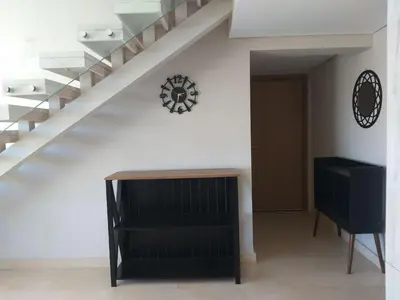 a hallway with a staircase with a clock on the wall at El Gouna Mangroovy 2Bd - M10 in El Gouna