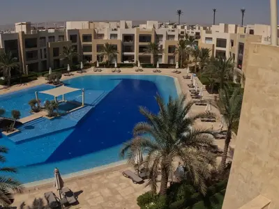 an overhead view of a swimming pool with palm trees and buildings at El Gouna Mangroovy 2Bd - M10 in El Gouna