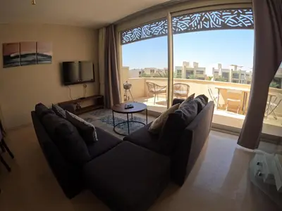 a living room with a couch and a large window at El Gouna Mangroovy 2Bd - M10 in El Gouna