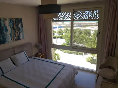 a bedroom with a bed and a large window at El Gouna Mangroovy 2Bd - M10 in El Gouna