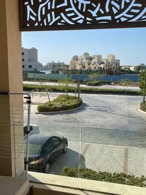 a car parked in a parking lot outside a building at Mangroovy- Sensational 1BR Sea & Kite view in Hurghada