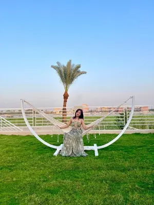 a woman in a dress posing in front of a hoop at Royal Nile Villas - Luxury Nile View Apartment 2 in Luxor