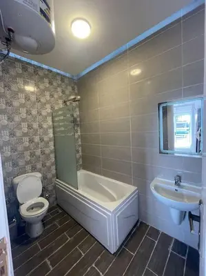 a bathroom with a tub and a toilet and a sink at Royal Nile Villas - Luxury Nile View Apartment 2 in Luxor