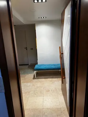 a hallway with a blue bench in a room at New Marina Hurghada Suite in Hurghada