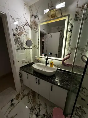 a bathroom with a sink and a mirror at New Marina Hurghada Suite in Hurghada