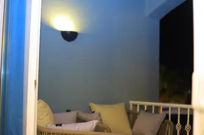 a room with a couch with a light on the wall at New Marina Hurghada Suite in Hurghada
