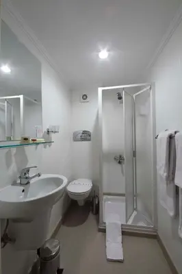 a bathroom with a sink and a shower and a toilet at Iberotel Helio Nile Cruise - Every Monday from Luxor for 07 & 04 Nights - Every Friday From Aswan for 03 Nights in Luxor