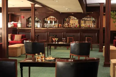 a restaurant with tables and chairs and a bar at Iberotel Helio Nile Cruise - Every Monday from Luxor for 07 & 04 Nights - Every Friday From Aswan for 03 Nights in Luxor