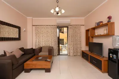 a living room with a couch and a tv at one bedroom apartment in Hurghada