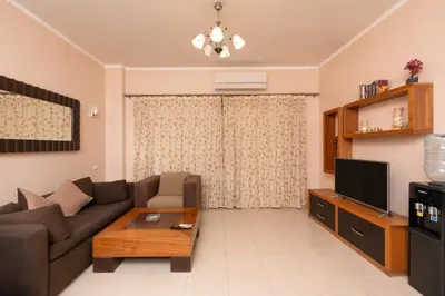 a living room with a couch and a tv at one bedroom apartment in Hurghada