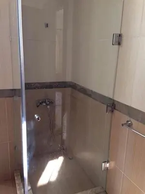 a shower with a glass door in a bathroom at Baron palace 41 in Hurghada