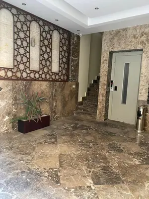 a lobby with a staircase and a door with tiles at Baron palace 41 in Hurghada