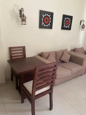 a living room with a couch and a table and chairs at Baron palace 41 in Hurghada