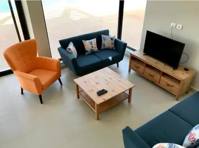 a living room with a couch and a tv and a chair at Emos Villa in Hurghada