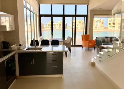 a large kitchen with a view of the ocean at Emos Villa in Hurghada