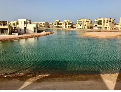 a large body of water in front of buildings at Emos Villa in Hurghada
