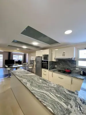 a large kitchen with a marble counter top at Apartment in el karma aqua beach resort hurghada near El gouna in Hurghada