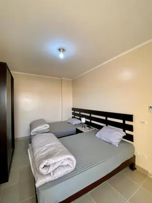 a bedroom with a bed with towels on it at Apartment in el karma aqua beach resort hurghada near El gouna in Hurghada