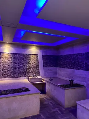a bathroom with two tubs and a blue lighting at Apartment in el karma aqua beach resort hurghada near El gouna in Hurghada
