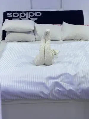 a white bed with two stuffed animals on it at KUBA LuXus tour - Hotel boat in sahl Hashesh - Hurghada in Hurghada