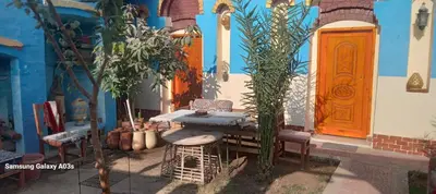 a table and chairs in front of a building at Golden Palace Family in Luxor