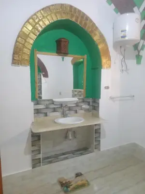 a bathroom with a sink and a mirror at Green Palace Garden in Luxor