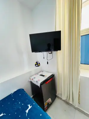 a room with a bed and a flat screen tv at ANA-KA Guest house in Aswan