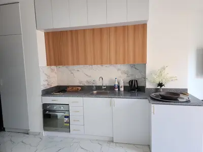 a kitchen with white cabinets and a sink at Hurghada Marina in Hurghada
