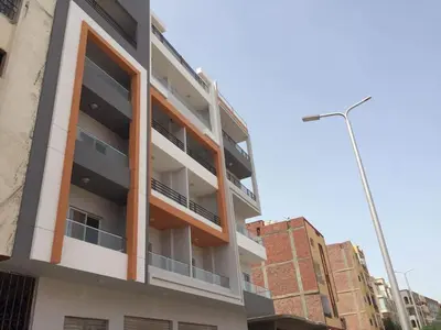 an apartment building with balconies on a city street at Hurghada Marina in Hurghada