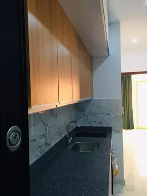 a kitchen with a sink and wooden cabinets at Hurghada Marina in Hurghada