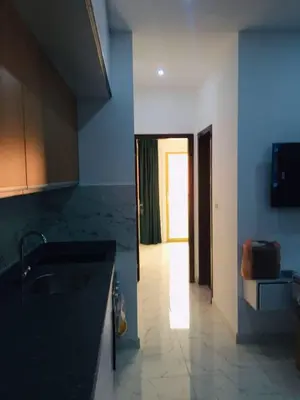 a kitchen with a sink and a door to a hallway at Hurghada Marina in Hurghada