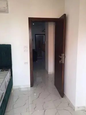 a hallway with a wooden door and a tiled floor at Hurghada Marina in Hurghada