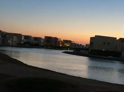 a body of water with buildings in the background at Apartment in Tawila ElGouna The Butterfly in Hurghada