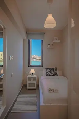 a small bedroom with a bed and a window at Apartment in Tawila ElGouna The Butterfly in Hurghada