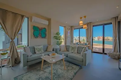 a living room with two couches and a table at Apartment in Tawila ElGouna The Butterfly in Hurghada