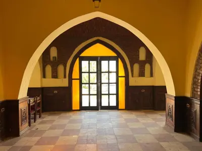 an arched entryway with a door in a building at Elphardous Oasis Hotel in Luxor