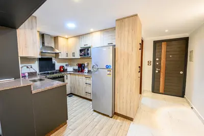 a kitchen with a stainless steel refrigerator and wooden cabinets at Rhapsody of Luxor in Luxor